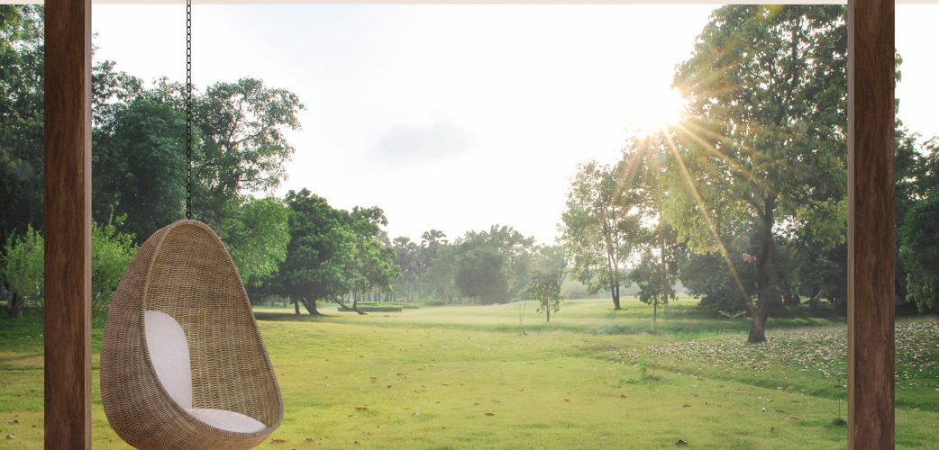 Wooden terrace with morning garden view 3d render, There are wooden floor,Decorate with rattan egg shaped chair,looking out over the large lawn.